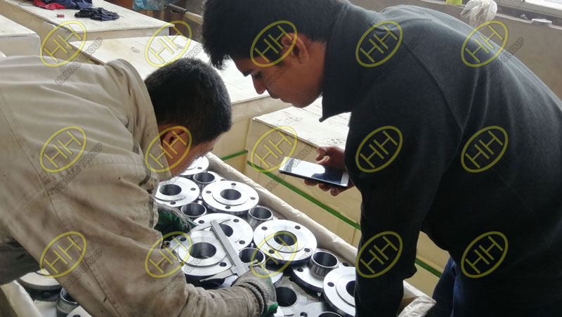 Customer inspects flange and fitting product quality